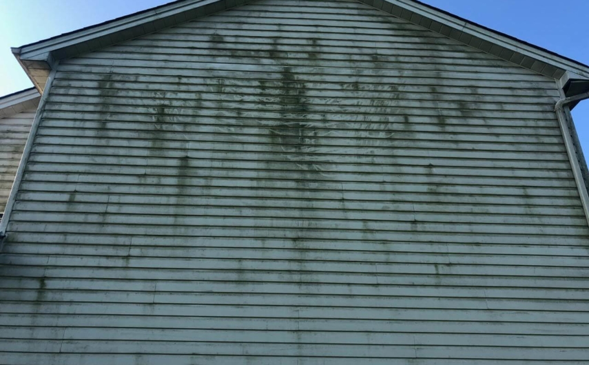 Dirty siding on white, two-story house. Dirty siding on white, two-story house.